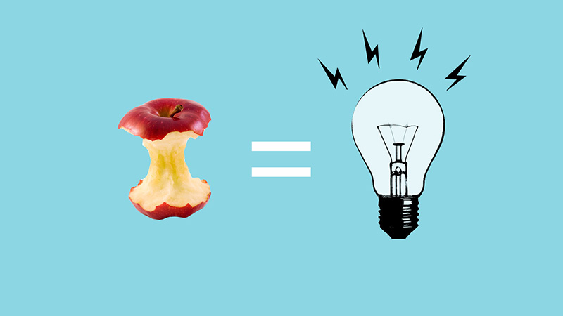 Na imagem é ilustrada uma maçã comida comparada à uma lâmpada acesa através de um símbolo de igual, indicando que resíduos orgânicos podem ser transformados em energia. O fundo da imagem é de cor azul vibrante.